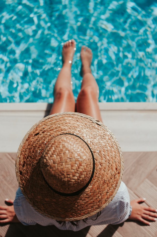 Woman sitting by pool