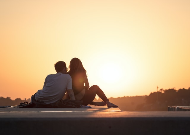 Couple sitting together at sunset